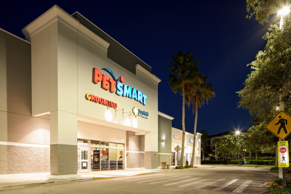 PetSmart storefront at night with illuminated signage, showcasing clear visibility and a welcoming exterior.