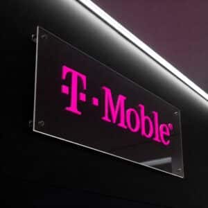 "Illuminated T-Mobile sign, featuring pink LED lettering on a modern storefront display.
