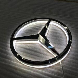 Illuminated corporate logos, like this Mercedes-Benz emblem, often utilize premium materials and finishes to create a sophisticated visual impact and reinforce brand identity.