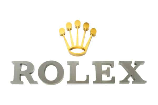 High-end brands like Rolex often choose fabricated metal signage for its durability and sophisticated appearance, reinforcing their brand identity with quality materials.