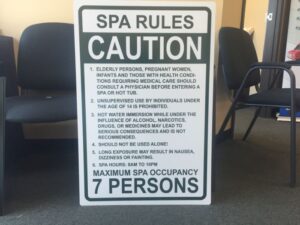 Informational amenity sign displaying "SPA RULES" with cautionary instructions and operating hours at an apartment complex, designed to enhance residents' experience and communicate guidelines clearly.